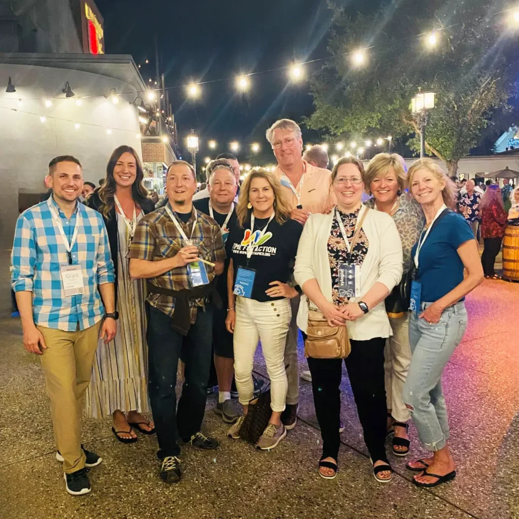 group of people standing together for a photo and smiling
